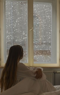 Caucasian woman looking out window