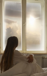 Caucasian woman looking out window