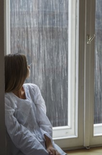 Caucasian woman looking out window