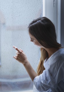 Caucasian woman looking out window