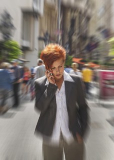 Caucasian businesswoman talking on cell phone in city