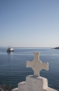 Cross on traditional arch and seascape