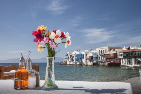 Seasonings and flowers on oceanfront cafe table
