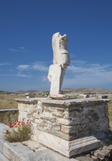 Statue ruins on stone pedestal
