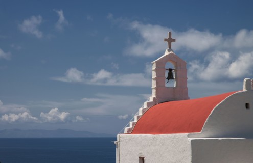 Traditional bell arch and seascape under blue sky