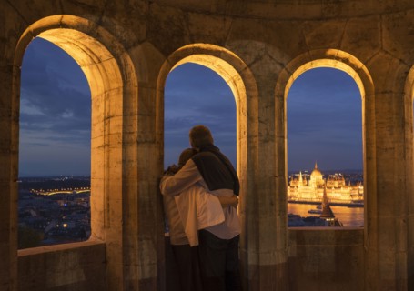 Tourists admiring cityscape from arch