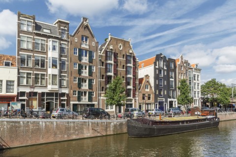 Boat docked on urban canal