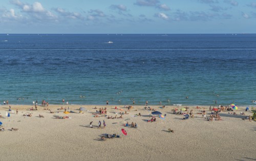 Tourists sunbathing on beach