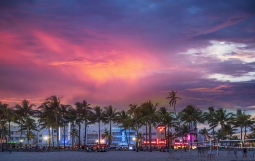 Beachfront buildings under sunset sky