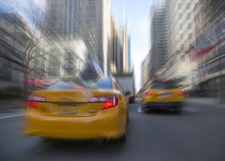 Blurred view of taxis driving on New York street