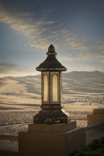 Ornate lantern on wall in desert