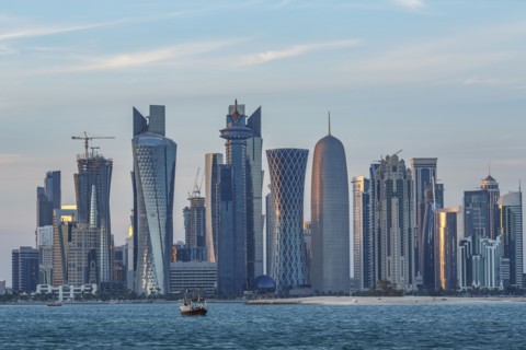Boat floating near Doha skyline