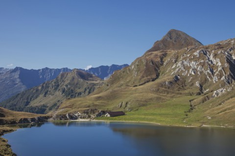 Mountains over still lake in remote landscape