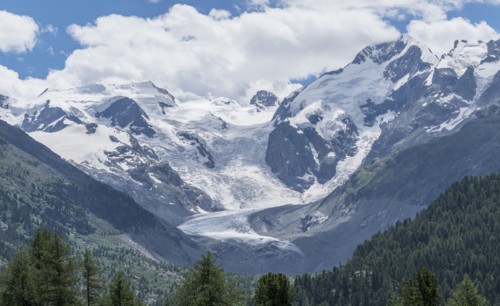 Clouds over snowy mountain range