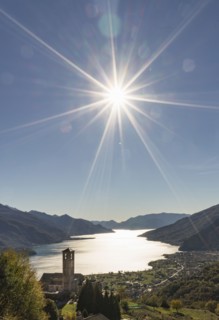 Sun in blue sky over Gravedona
