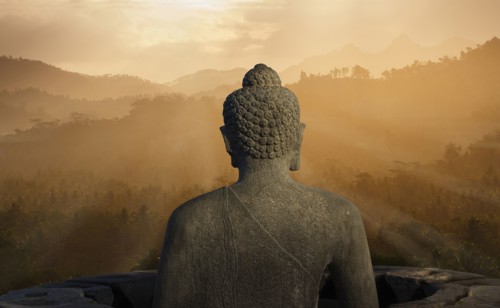 Statue of Buddha at sunset