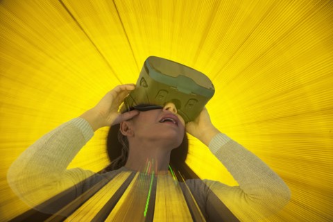 Caucasian woman wearing virtual reality goggles