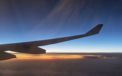 Wing of airplane flying in sky