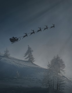 Silhouette of Santa and reindeer flying sleigh in winter