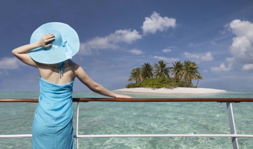Caucasian woman admiring scenic view of island from boat