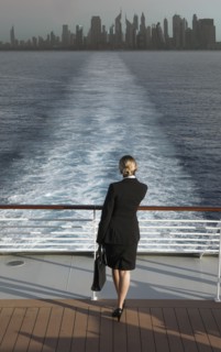 Caucasian businesswoman on boat leaving city