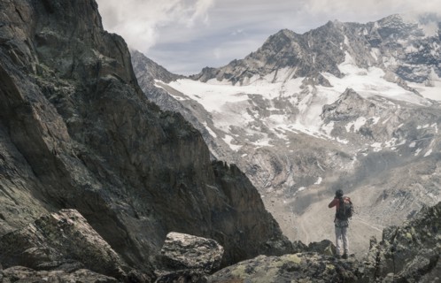 Caucasian man hiking on snowy mountain