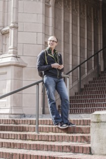 Caucasian student standing on campus staircase