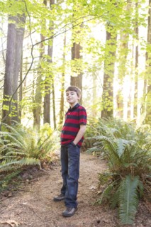 Caucasian boy standing on path in forest