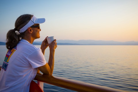 Caucasian woman overlooking ocean from boat deck