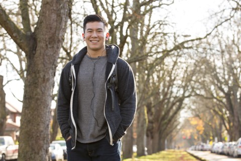 Mixed race man walking on suburban street