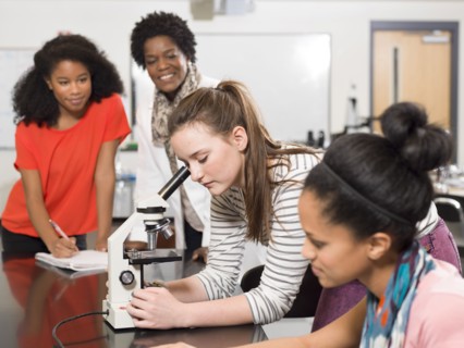 Students and teacher working in chemistry lab