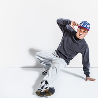 Mixed race dancer casting shadows on wall