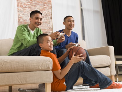 Mixed race brothers playing video games together