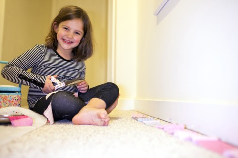 Caucasian girl crafting in playroom