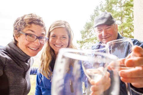 Caucasian family drinking wine together