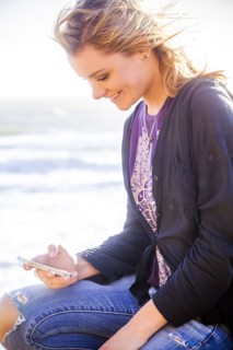 Caucasian girl using cell phone outdoors