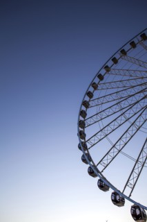 Low angle view of ferris wheel against blue sky