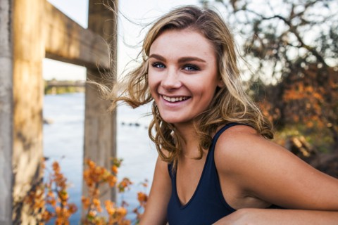 Caucasian teenage girl smiling outdoors