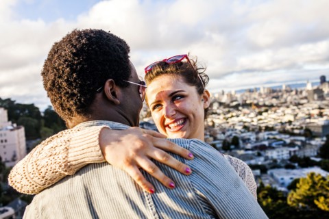 Couple hugging near scenic view of cityscape