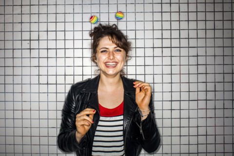 Caucasian woman wearing colorful antenna near wall