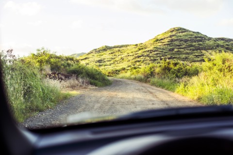 Sandy road viewed through car windshield
