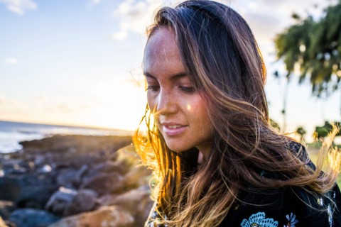Close up of Caucasian woman on rocky beach