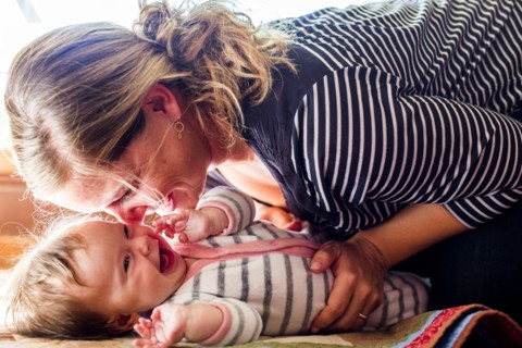 Smiling Caucasian mother cradling baby girl