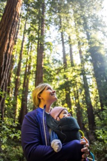 Low angle view of Caucasian mother carrying daughter in forest