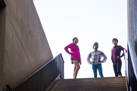 Runners standing at top of urban staircase
