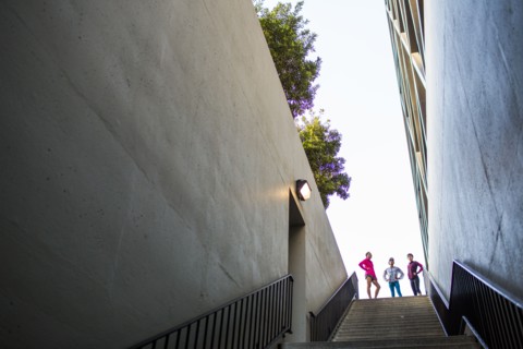 Runners standing at top of urban staircase