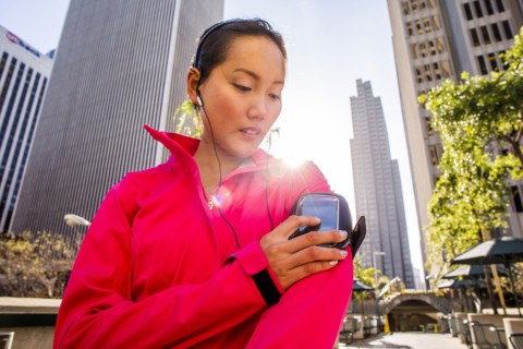 Runner using cell phone in city
