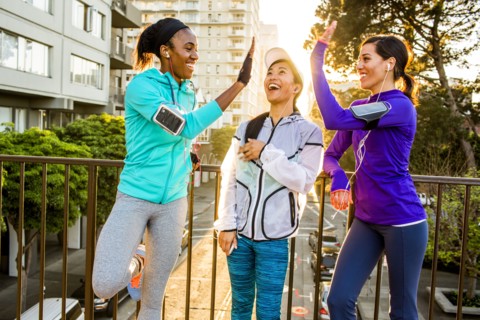 Runners high-fiving in city