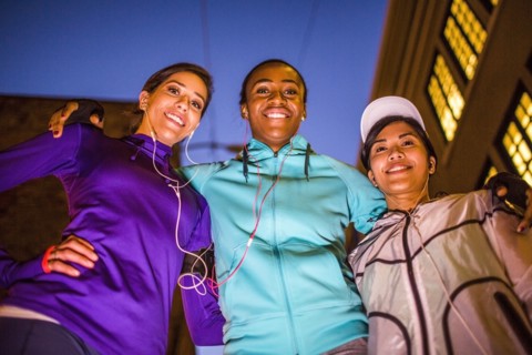 Low angle view of runners smiling at night