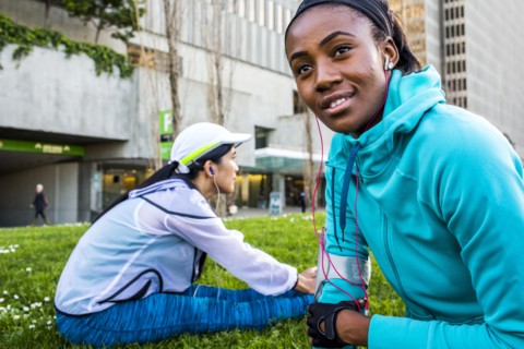 Runners stretching in urban park